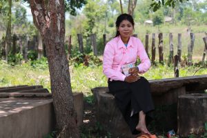 Koh Ker's first PLF graduate, Sareng, who is now the school's librarian, sitting at the site of the new library.