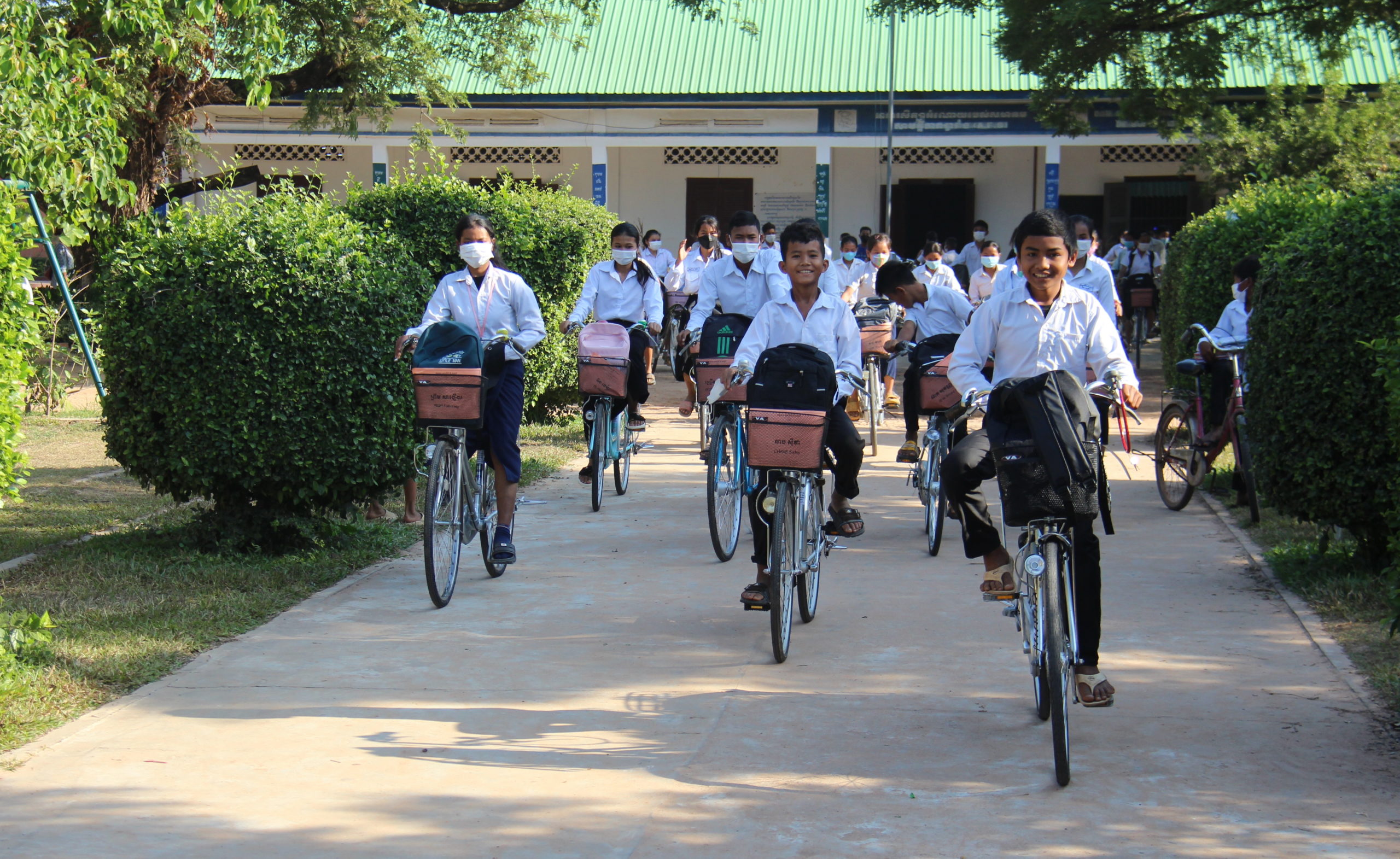 Tchey students cycling home on distribution day Tchey students cycling home on distribution day